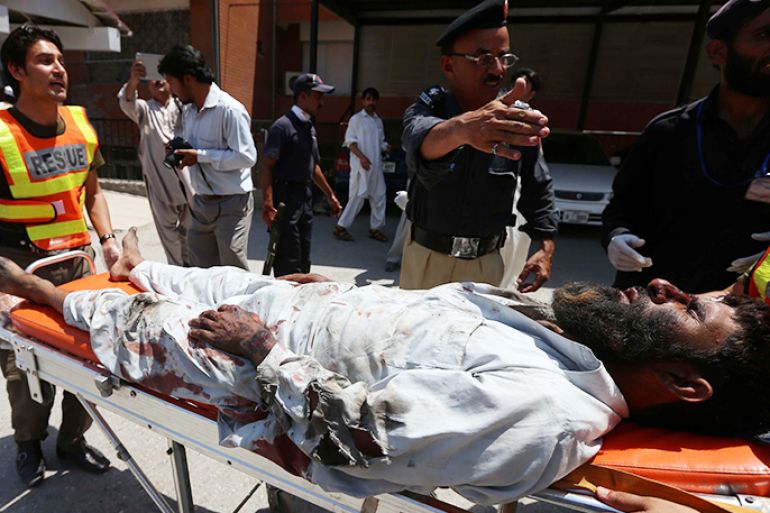 epa03754080 A man who was injured in a suicide bomb attack at a Mosque, is rushed on a stretcher to a hospital in Peshawar, Pakistan, 21 June 2013. At least 10 people were killed and more than 15 injured on 21 June in a suicide bombing inside a Shiite mosque in Pakistan's troubled north-western region, officials said. The incident occurred in Gulshan Colony in the suburbs of Peshawar, the capital of Khyber-Pakhtunkhwa province, as worshippers were preparing for Friday prayers. EPA/BILAWAL ARBAB