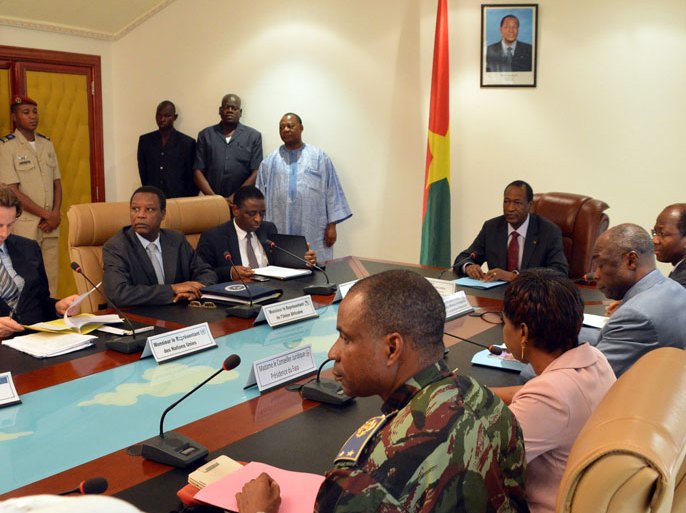 President Blaise Compaore of Burkina Faso (C) UN representative Bert Koenders (l), and African Union representative Pierre Buyoya (2nd l) meet represtatives of Toureg rebels and the Malian government on June 10, 2013 at the presidential palace in Ouagadougou.