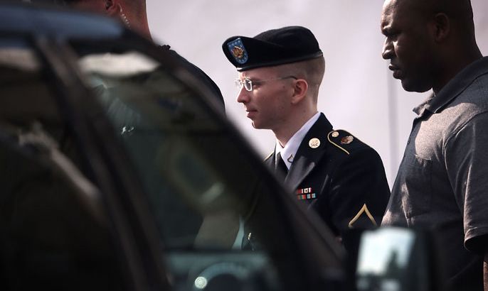 U.S. Army Private First Class Bradley Manning (C) is escorted as he leaves a military court for the day June 3, 2013 at Fort Meade in Maryland. Manning was due to face court martial for allegedly sending hundreds of thousands of government documents to Wikileaks for aiding the enemy