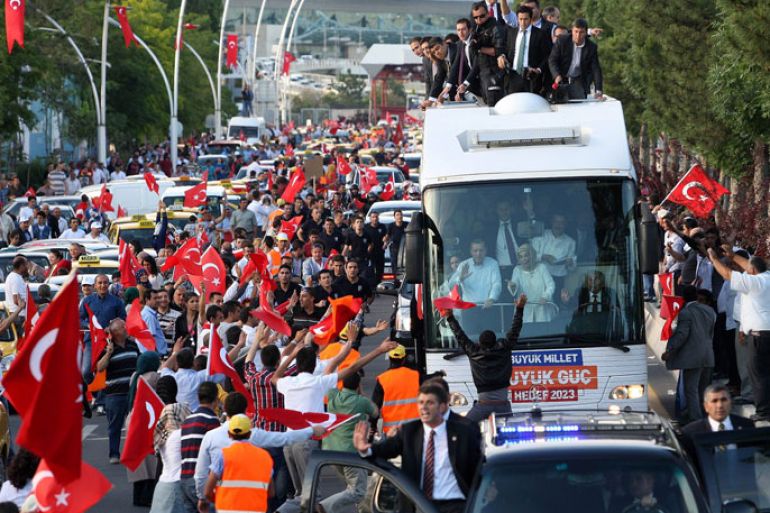 Turkish Prime Minister Recep Tayyip Erdogan (at left in bus) and his wife Emine wave to supporters on their arrival in Ankara on June 9, 2013. Erdogan warned today that the patience of his Islamic-rooted government "has a limit" as mass protests against his decade-long rule raged for a 10th day