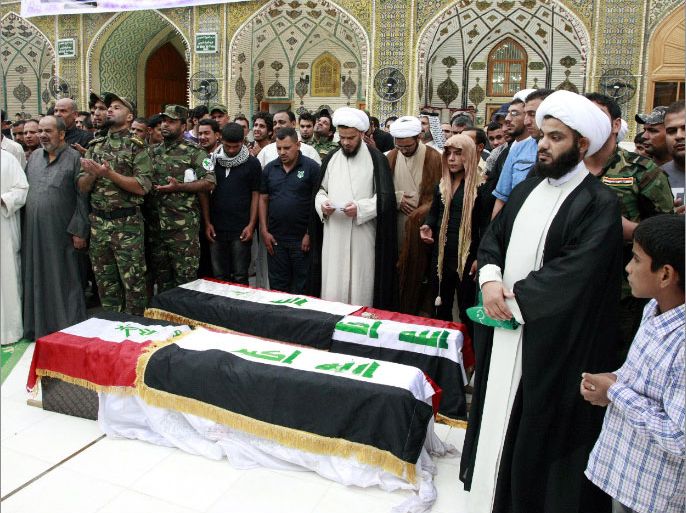 epa03687400 Members of the Iraqi Shiite militia, Asaib Ahl Al-Haq, along with Shiite clerics pray over the coffins of their comrades who were reportedly killed in the fight in Syria against the Free Syrian Army, during the funeral processions in Najaf, south of Iraq, 04 May 2013. According to media reports, hundreds of the Shiite Iraqi militia had allegedly joined to fight with the Syrian government forces against the Free Syrian Army. EPA/KHIDER ABBAS
