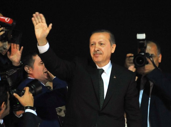 DEC009 - Istanbul, -, TURKEY : Turkish Prime Minister Recep Tayyip Erdogan salutes supporters upon arrival at Ataturk International Airport in Istanbul on June 7, 2013. Turkey's Islamic-rooted government apologised to wounded protestors and said it had "learnt its lesson" after days of mass street demonstrations that have posed the biggest challenge to Prime Minister Recep Tayyip Erdogan's decade in office. Turkish police had on June 1 begun pulling out of Istanbul's iconic Taksim Square, after a second day of violent clashes between protesters and police over a controversial development project. What started as an outcry against a local development project has snowballed into widespread anger against what critics say is the government's increasingly conservative and authoritarian agenda. AFP PHOTO / OZAN KOSE