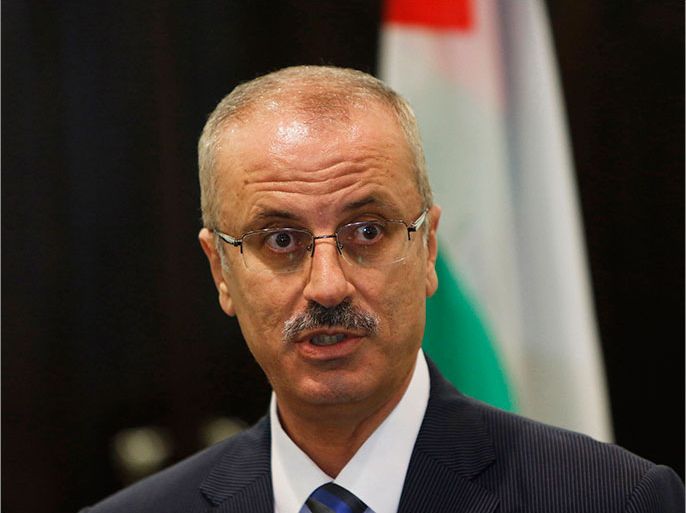 Palestinian Prime Minister Rami Hamdallah speaks during a joint news conference with European Union foreign policy chief Catherine Ashton (not seen) in the West Bank city of Ramallah, in this file picture taken June 19, 2013. The newly appointed Palestinian Prime Minister Hamdallah has offered his resignation to President Mahmoud Abbas, a government source said on June 20, 2013. It was not immediately clear whether Abbas had accepted the resignation or why Hamdallah, who was sworn in on June 6, had decided to quit. Picture taken June 19, 2013. REUTERS/Mohamad Torokman/Files (WEST BANK - Tags: POLITICS)