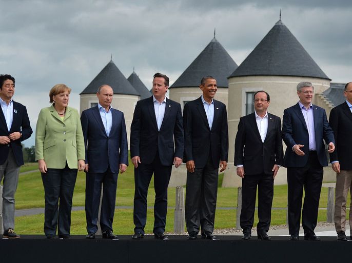 G8 leaders (L-R) Japan's Prime Minister Shinzo Abe, Germany's Chancellor Angela Merkel, Russia's President Vladimir Putin, Britain's Prime Minister David Cameron, US President Barack Obama, France's President Francois Hollande, Canada's Prime Minister Stephen Harper and Italy's Prime Minister Enrico Letta stand on the podium for the family photograph on the second day of the G8 summit at the Lough Erne resort near Enniskillen in Northern Ireland on June 18, 2013. Russia and the US agreed at the G8 summit to push for Syria peace talks, but Presidents Vladimir Putin and Barack Obama made clear their deep differences over the conflict. AFP PHOTO