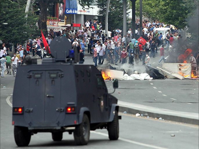A police armored vehicle approaches a makeshift barricade setup by demonstrators, during clashes between protesters and riot police in Ankara on June 16, 2013. Turkish Prime Minister Recep Tayyip Erdogan rallied tens of thousands of his supporters in Istanbul today, hours after ordering a crackdown on anti-government protesters in a city park and sending tensions soaring in two weeks of unrest. AFP PHOTO / ADEM ALTAN