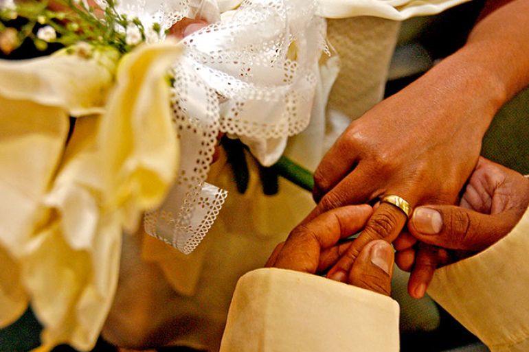 A Filipino couple exchange rings during a mass wedding ceremony in Makati City, southern Manila, Philippines on 05 June 2009. More than 30 couples were wed in a mass wedding ceremony sponsored by the local government. EPA/ALANAH M. TORRALBA