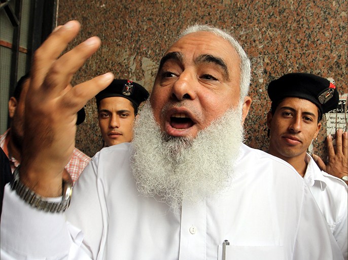 epa03415762 Egyptian Muslim Sheikh Ahmed Mohamed Abdullah, aka Abu-Islam, speaks to reporters outside the court where he is tried on charges of insulting religion, in Cairo, Egypt, 30 September 2012. Media reports state that Abu-Islam and his son were referred to the court on charges of allegedly tearing pages of the Bible during a protest outside the US embassy in Cairo against the US-made anti-Islam film. The trial was adjourned to 14 October. Anti-blasphemy laws in Egypt can punish anyone who insults a ?heavenly religion? by up to five years in prison. EPA/KHALED ELFIQI