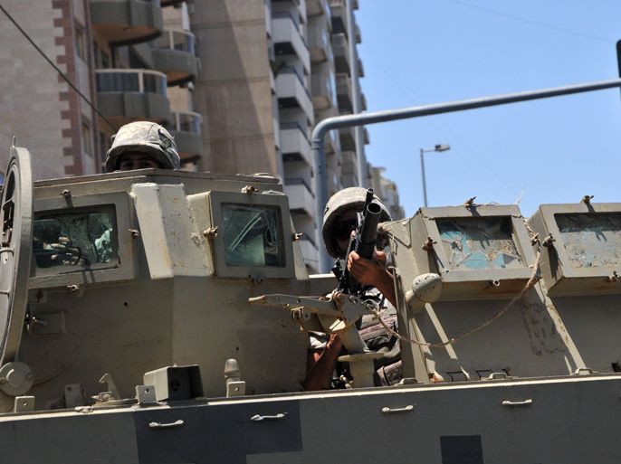 JE07 - Tripoli, -, LEBANON : Lebanese Army Forces patrol with an armoured vehicle on June 6, 2013 in the eastern Lebanese city of Tripoli. The wave of bloody violence that hits Tripoli is tied to the conflict in Syria, where a Sunni-led uprising is fighting to overthrow the regime of President Bashar al-Assad, an Alawite. AFP PHOTO IBRAHIM CHALHOUB