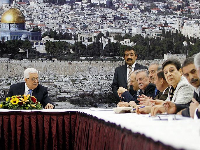 Palestinian President Mahmoud Abbas (L) attends a meeting of the Palestinian leadership in the West Bank city of Ramallah July 18, 2013. As Palestinian leaders discussed a possible U.S-brokered resumption of peace talks on Thursday, the Israeli government denied a shift in its conditions that might help end a three-year stalemate. Abbas began briefing fellow PLO leaders in Ramallah on his meetings this week with U.S. Secretary of State John Kerry, who has extended his stay in the region and appears to be hoping for some movement toward talks. REUTERS/Mohamad Torokman (WEST BANK - Tags: POLITICS)