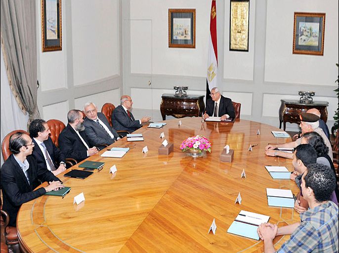 Egypt's interim President Adli Mansour (C) talks to senior opposition figure Mohamed El Baradei, to be named as interim Prime Minister, and members of the Tamarud "rebel" protest movement at El-Thadiya presidential palace in Cairo in this handout picture dated July 6, 2013. REUTERS/Egyptian Presidency/Handout (EGYPT - Tags: POLITICS BUSINESS)