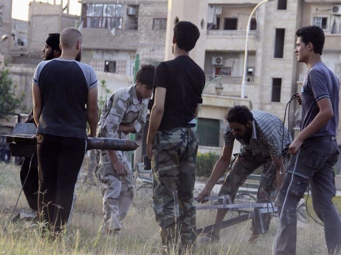 Free Syrian Army fighters prepare a homemade missile in Deir al-Zor July 19, 2013. Picture taken July 19, 2013.