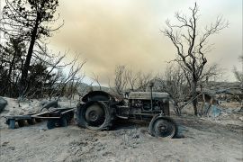 IDYLLWILD, CA - JULY 18: A farming tractor is left in the wake of the Mountian Fire after it scorched the area on July 18, 2013 near Idyllwild, California. The massive wildfire in Riverside county has grown to 23,000 acres and is advancing towards the mountain town of Idyllwild on one front and city of Palm Springs on the other front destroying several homs and forcing the evacuation of 6,000 people. Kevork Djansezian/Getty Images/AFP== FOR NEWSPAPERS, INTERNET, TELCOS & TELEVISION USE ONLY ==