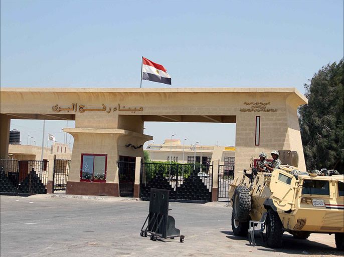epa03344700 An Egyptian army armored vehicle is seen next to the closed Rafah border crossing, one day after an attack on an Egyptian checkpoint in Rafah, Egypt, 06 August 2012. Media reports state that 16 Egyptian security forces were killed and seven others injured on 05 August when militants opened fire on a checkpoint and commandeered vehicles during a Ramadan fast in Rafah. Having hijacked the vehicles, they raced to the nearby Kerem Shalom/Karm Abu Salem crossing point on the Egypt-Israel-Gaza border. Egyptian authorities closed the border crossing with the Gaza Strip at Rafah indefinitely. EPA/AHMED KHALED
