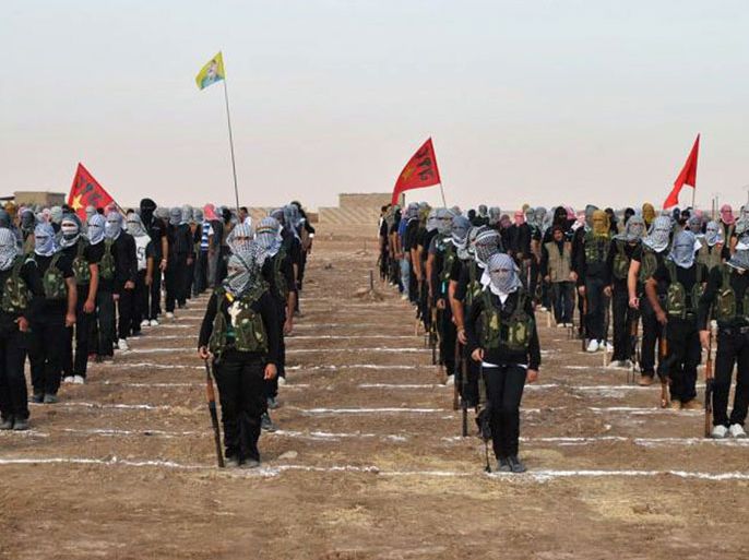 Kurdish opposition fighters attend a ceremony on July 18, 2013, in the northern Syrian border village of al Qamishli. At least 29 people have been killed in fighting between Kurdish and jihadist fighters in northern Syria in the past two days, the Syrian Observatory for Human Rights said.