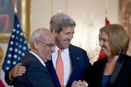 US Secretary of State John Kerry (C) looks on as chief Palestinian negotiator Saeb Erakat (L) and Israel's Justice Minister Tzipi Livni (R) shake hands after speaking at the State Department in Washington on July 30, 2013. Israeli and Palestinian negotiators agreed Tuesday to meet again within the next two weeks, aiming to seal a final peace deal in nine months, Kerry said. The two sides will meet in either Israel or the Palestinian territories and "our objective will be" to reach a "final status agreement over the course of the next nine months," Kerry told reporters after Israelis and Palestinians ended a three-year freeze on talks.