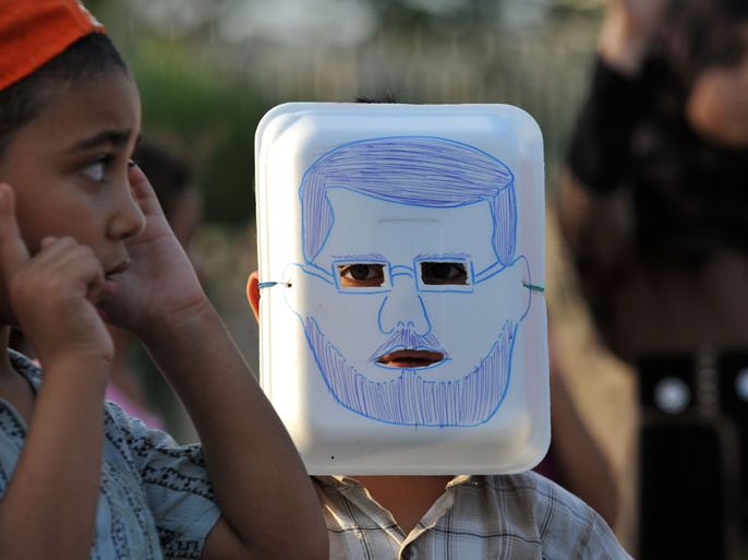 A Young Egyptian supporter of ousted president Mohamed Morsi wearing a mask with a drawing depicting the ousted president, attends a children march to protest against the death of Morsi supporters in Cairo's eastern Nasr City district on July 29, 2013. Egyptian protesters loyal to deposed president Mohamed Morsi called for a "million person march" on July 30
