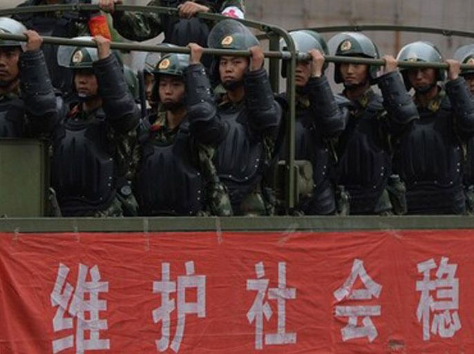 •	Caption:Chinese paramilitary police ride in trucks during a 'show of force' ceremony in Urumqi after a series of terrorist attacks recently hit Xinjiang Province, on June 29, 2013. Armoured vehicles, personnel carriers and other support vehicles blocked access to streets in Xinjiang's capital Urumqi, where paramilitary units carried out an exercise. The exercises come ahead of the fourth anniversary on July 5 of riots, between members of China's mostly Muslim Uighur ethnic minority and the Han majority group, which left around 200 dead.