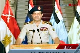 An image grab taken from Egyptian state TV shows Egyptian Defence Minister Abdelfatah al-Sissi delivering a statement on July 3, 2013 as the army unveils a roadmap for Egypt's political future, with state media reporting that the plan sets a tight schedule for new elections. A top aide to Egypt's President Mohamed Morsi slammed what he called a "military coup" as an army ultimatum passed and the security forces slapped a travel ban on the Islamist leader AFP PHOTO/EGYPTIAN TV == RESTRICTED TO EDITORIAL USE - MANDATORY CREDIT "AFP PHOTO / EGYPTIAN TV" - NO MARKETING NO ADVERTISING CAMPAIGNS - DISTRIBUTED AS A SERVICE TO CLIENTS ===