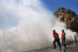 CHINA : This picture taken on July 12, 2013 shows huge waves surging up against the shoreline of Diaobin fishing port in Wenling city, east China's Zhejiang province. Eastern China was on July 14 bracing for torrential downpours from Typhoon Soulik which forced the evacuation of half a million people after killing two in Taiwan. CHINA OUT AFP PHOTO