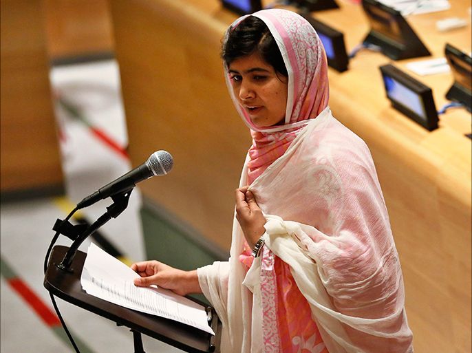 Malala Yousafzai, wearing a white shawl that had belonged to former Pakistani Prime Minister Benazir Bhutto, gives her first speech since the Taliban in Pakistan tried to kill her for advocating education for girls, at the United Nations Headquarters in New York, July 12, 2013. Wearing a pink head scarf, Yousafzai told U.N. Secretary-General Ban Ki-moon and nearly 1,000 students from around the world attending a Youth Assembly at U.N. headquarters in New York that education was the only way to improve lives. REUTERS/Brendan McDermid (UNITED STATES - Tags: POLITICS CRIME LAW)