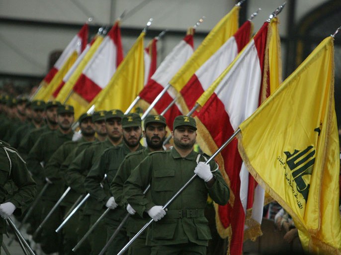 LEBANON : (FILES) A picture taken on November 11, 2009, shows Hezbollah fighters, holding up Lebanese flags and the yellow flag of the militant Shiite Muslim group, as they parade on the occasion of Martyr's Day in the southern suburbs of Beirut. EU foreign ministers decide on July 22, 2013 whether to blacklist the military wing of Lebanon's Hezbollah group, with an eye also on the conflict in Syria and the possible resumption of stalled Israel-Palestinian talks