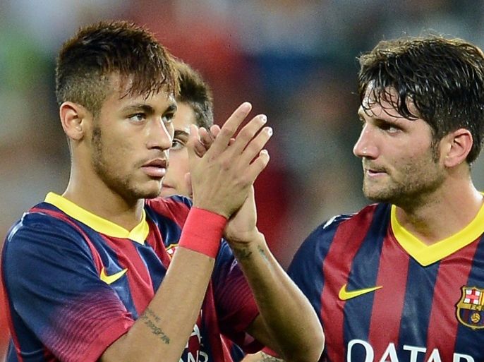 Barcelona's defender Carles Planas (R) reacts with teammate Neymar while leaving the pitch with teammates after their preseason friendly football match Lechia Gdansk vs FC Barcelona at the PGE Arena in Gdansk, on July 30, 2013. The match ended 2-2.