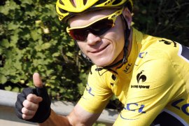 Overall leader's yellow jersey Britain's Christopher Froome thumbs up as he rides at the start of the 133.5 km twenty-first and last stage of the 100th edition of the Tour de France cycling race on July 21, 2013 between Versailles and Paris. AFP PHOTO / PASCAL GUYOT