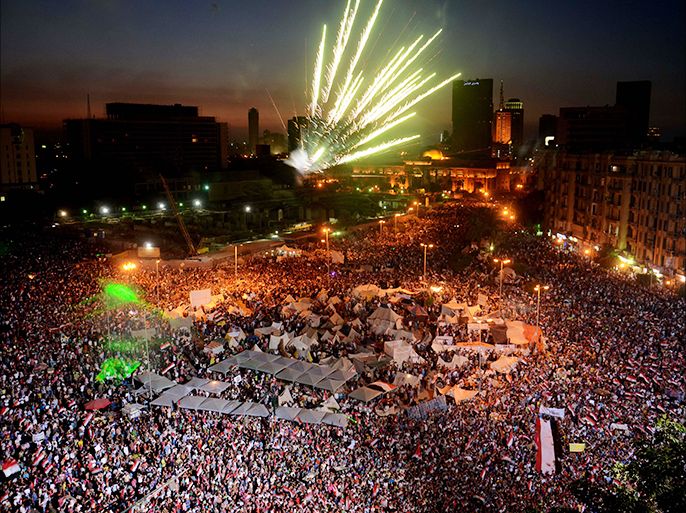 epa03770303 A general view shows fireworks above Tahrir square as Egyptians celebrate the Egyptian military reaction to the protests against President Morsi, in Tahrir square, Cairo, Egypt, 01 July 2013. The army gave Egyptian President Mohamed Morsi and the opposition a 48-hour ultimatum to reach consensus and meet the people's demands or it would announce measures to end the stalemate. EPA/HASSIM DABI