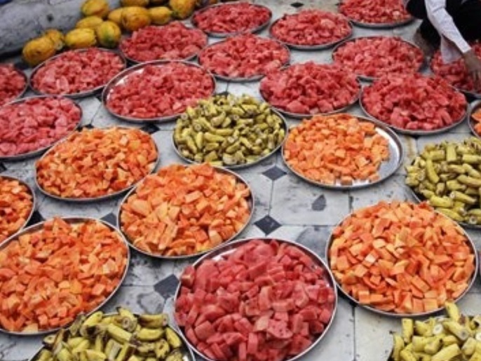 An Indian Muslim prepares cut fruits for others before breaking his fast at a mosque during the holy month of Ramadan, in Ahmadabad, India, Sunday, Aug. 28, 2011.