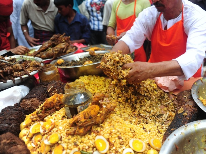 Bangladeshi street vendors prepare Iftar food for breaking the daytime fast, on the first day of Ramadan, the holy fasting month of Islam, at a traditional bazaar in the old part of Dhaka on July 11 , 2013. Like millions of Muslim around the world, Bangladeshi Muslims celebrated the month of Ramadan by abstaining from eating, drinking, and smoking as well as sexual activities from dawn to dusk.