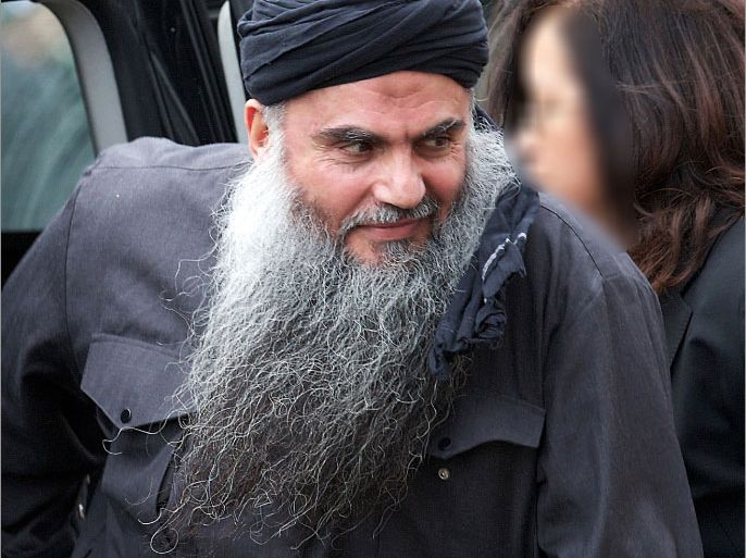(FILES) In this file picture taken on November 13, 2012 radical Jordanian cleric Abu Qatada arrives at his home in northwest London , after he was released from prison. Jordan's parliament has approved an agreement with Britain on extraditing