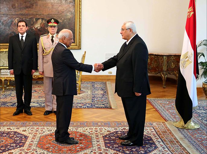 epa03789952 A handout photo released by the Egyptian Presidency shows Egyptian interim President Adli Mansour (R) shaking hands with Prime Minister Hazem Beblawi (L), during the swearing in ceremony in Cairo, Egypt, 16 July 2013. Members of Egypt's interim cabinet were sworn-in on 16 July as a new Ministry for Transitional Justice and National Reconciliation was introduced. Army chief and Defence Minister Abdel Fattah al-Sissi, the architect of Morsi's removal from power, retained his post while also gaining the title of deputy prime minister. EPA/EGYPTIAN PRESIDENCY/HANDOUT HANDOUT EDITORIAL USE ONLY/NO SALES