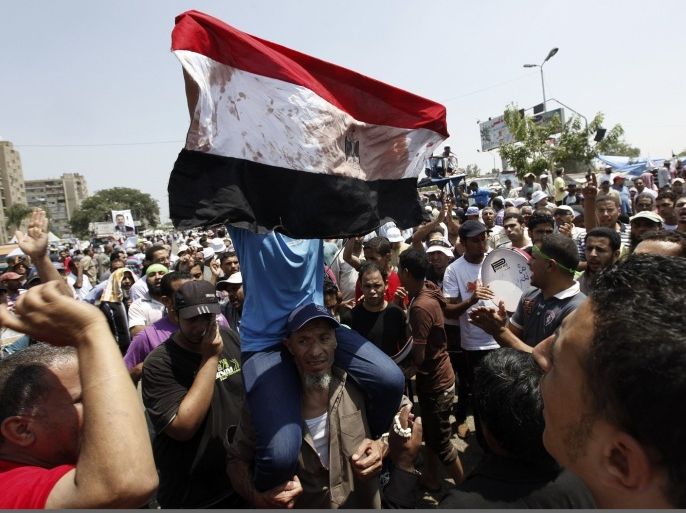 Members of the Muslim Brotherhood and supporters of deposed Egyptian President Mohamed Mursi shout slogans at Republican Guard headquarters in Nasr City, in the suburb of Cairo July 8, 2013.