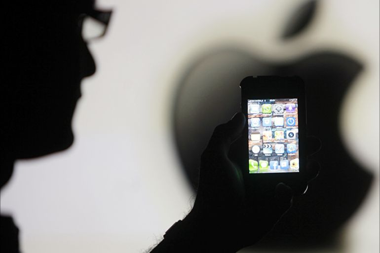 A man is silhouetted against a video screen with an Apple logo as he poses with an Apple iPhone 4 smartphone in this file photo illustration taken in the central Bosnian town of Zenica May 17, 2013. Samsung, the South Korean giant, now has a 19 percent share of the $80 billion smartphone market in China, a market expected to surge to $117 billion by 2017, according to International Data Corp (IDC). That's 10 percentage points ahead of Apple, which has fallen to 5th in terms of China market share. Picture taken May 17, 2013. To match Insight story SAMSUNG-APPLE/CHINA REUTERS/Dado Ruvic/Files (BOSNIA AND HERZEGOVINA - Tags: SCIENCE TECHNOLOGY BUSINESS TELECOMS)