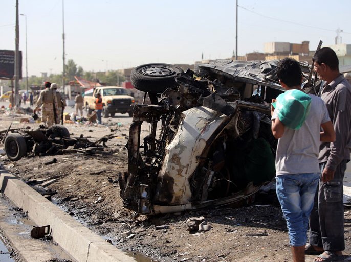 AHR8 - Baghdad, -, IRAQ : Iraqis inspect the site of a car bomb explosion in the impoverished district of Sadr City in Baghdad on July 29, 2013, after 11 car bombs hit nine different areas of Baghdad, seven of them Shiite-majority, while another exploded in Mahmudiyah to the south of the capital. More than 3,000 people have been killed in violence since the beginning of the year, according to AFP figures based on security and medical sources -- a surge in unrest that the Iraqi government has so far failed to stem. AFP PHOTO/AHMAD AL-RUBAYE