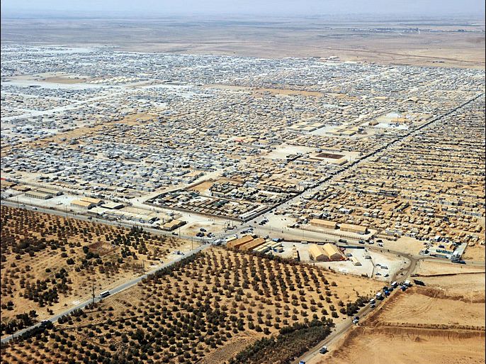 An aerial view shows the Zaatari refugee camp on July 18, 2013 near the Jordanian city of Mafraq, some 8 kilometers from the Jordanian-Syrian border. The northern Jordanian Zaatari refugee camp, now home to 160,000 Syrians, equal in size to what would be Jordan's fifth-largest city. AFP PHOTO/MANDEL NGAN/POOL