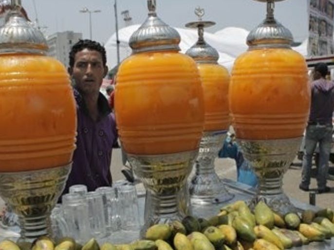 An Egyptian street vendor offers cold mango juice for sale in Tahrir Square as demonstrators are still camping out for the fourth day, in Cairo, Egypt Monday, July 11, 2011. Egypt's benchmark stock index dropped by more than 2.6 percent Monday, dragged down by concerns of mounting unrest in the Arab world's most populous nation.