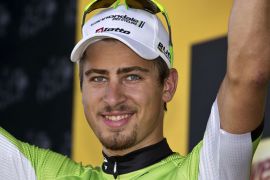 Stage winner Slovakia's Peter Sagan celebrates his green jersey of best sprinter on the podium at the end of the 205.5 km seventh stage of the 100th edition of the Tour de France cycling race on July 5, 2013 between Montpellier and Albi, southwestern France. AFP PHOTO / JOEL SAGET