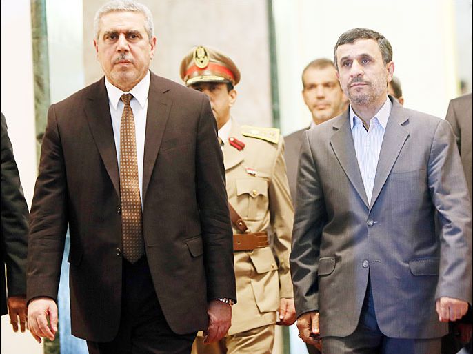 Iranian outgoing President Mahmoud Ahmadinejad (R) arrive to meet with Iraqi Vice President Khodair al-Khozaei (L) at the presidential palace in Baghdad, on July 18, 2013. Ahmadinejad arrived in Iraq for a two-day visit, during which he is to meet with senior officials and visit Shiite holy sites. AFP PHOTO/ALI AL-SAADI