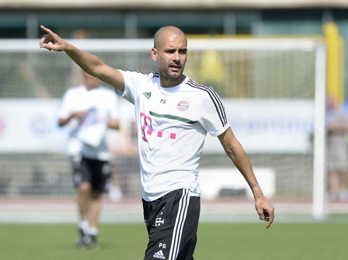 Bayern Munich's Spain head coach Pep Guardiola gestures during the training session at the team training camp of FC Bayern Munich in Arco, Italy, on July 9, 2013. AFP PHOTO/CHRISTOF STACHE