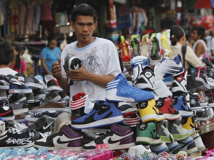 A man looks at sport shoes at a bargain center in Manila November 29, 2012. The Philippines' budget deficit narrowed to 9.67 billion pesos ($236 million) in October from the previous month as the government posted its second highest monthly revenue growth this year, allowing it to ramp up spending and boost economic activity.