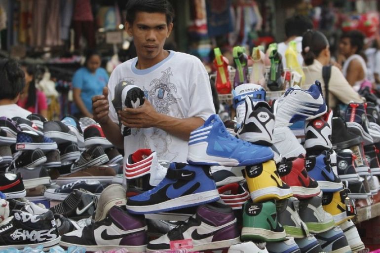 A man looks at sport shoes at a bargain center in Manila November 29, 2012. The Philippines' budget deficit narrowed to 9.67 billion pesos ($236 million) in October from the previous month as the government posted its second highest monthly revenue growth this year, allowing it to ramp up spending and boost economic activity.