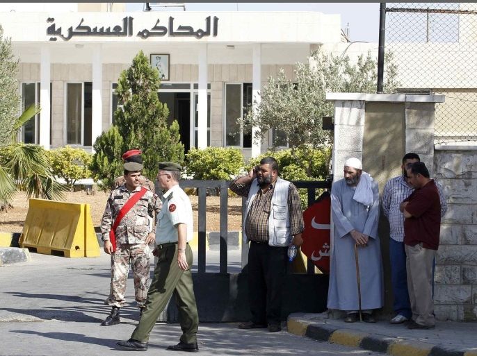 Family members of radical Muslim cleric Abu Qatada stand near the State Security Court in Amman July 7, 2013. Britain deported Qatada to Jordan on Sunday, ending eight years of government efforts to send him home for trial on charges of alleged terrorism.