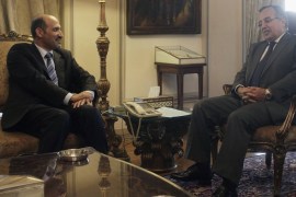 Ahmad Jarba (L), head of the opposition Syrian National Coalition, meets with Egyptian Foreign Minister Nabil Fahmy at the foreign ministry headquarters in Cairo July 21, 2013.