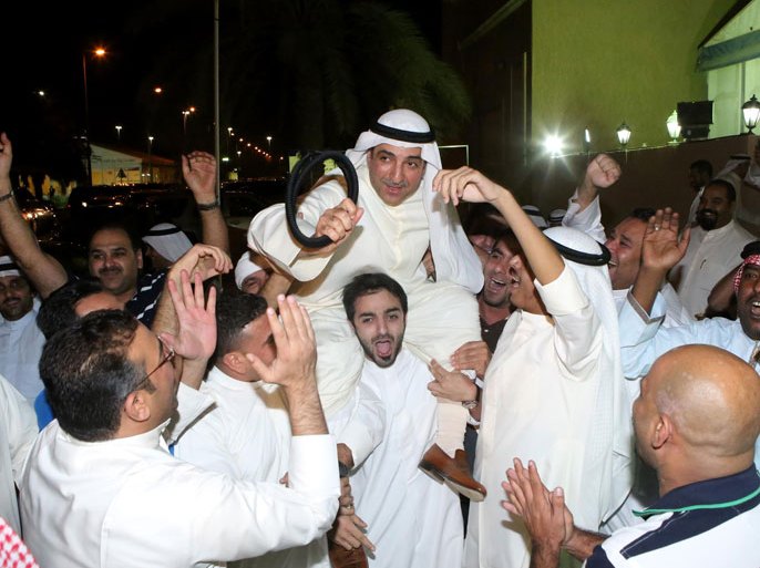 Kuwait City, -, KUWAIT : Kuwaiti Shiite candidate and former MP Yousef al-Zalzalah (C) celebrates with his supporters following his victory in the parliamentary elections in Kuwait City early on July 28, 2013. According to figures posted on the information ministry website, voter turnout was 52.5 percent, compared to December's record low of 40 percent due to opposition boycott. Average turnout at Kuwaiti polls is around 65 percent. AFP PHOTO/YASSER AL-ZAYYAT