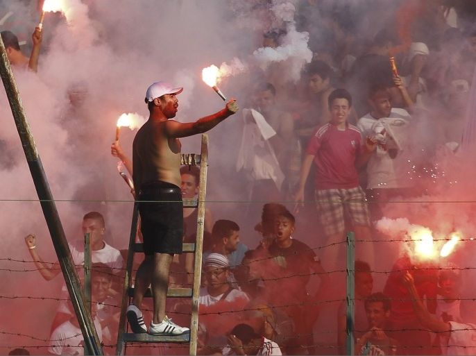 Zamalek's fans celebrate after their team scored a goal against derby rivals Al Ahly during their CAF Champions League soccer match at El-Gouna stadium in Hurghada, about 464 km (288 miles) from the capital Cairo July 24, 2013.