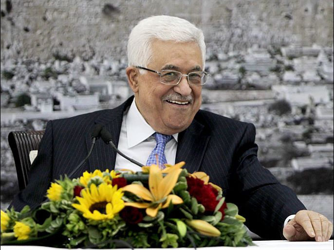 Palestinian president Mahmud Abbas smiles during a meeting with Palestinian central commitee in the West Bank city of Ramallah on July 18, 2013 to discuss the peace plan proposed by US Secretary of Sate John Kerry. The Palestinians demanded that changes be made to Kerry's Middle East peace plan, following the meeting an official said. AFP PHOTO/ABBAS MOMANI
