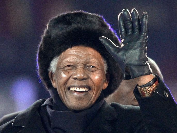 (FILES) -- A file photo taken on July 11, 2010 shows South Africa's former President Nelson Mandela waving as he arrives to attend the 2010 World Cup football final Netherlands vs. Spain at Soccer City stadium in Soweto, near Johannesburg. AFP PHOTO / THOMAS COEX