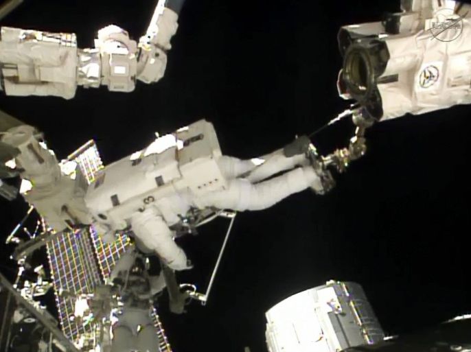 A frame grab from NASA TV shows Italian Air Force pilot and European Space Agency astronaut Luca Parmitano (Top) and NASA astronaut Chris Cassidy of the US (Bottom) during a space walk outside the International Space Station on 09 July 2013. The astronauts were scheduled to spend more than six hours preparing the space station for the installation of a Russian module and other tasks. Parmitano is the first Italian astronaut to walk in space, according to NASA.