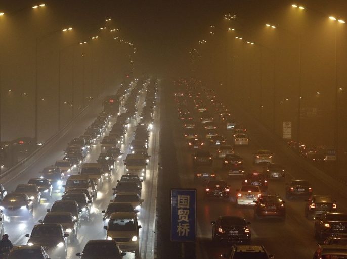 Vehicles drive on the Third Ring Road on a very hazy winter day in Beijing in this January 12, 2013 file photo. Eight more cities in China, the world's biggest auto market, are likely to announce policies restricting new vehicle purchases, an official at the automakers association said, as Beijing tries to control air pollution.